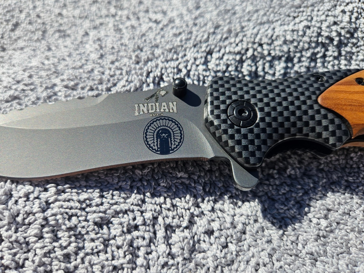 Indian Nation engraved folding knives on fabric