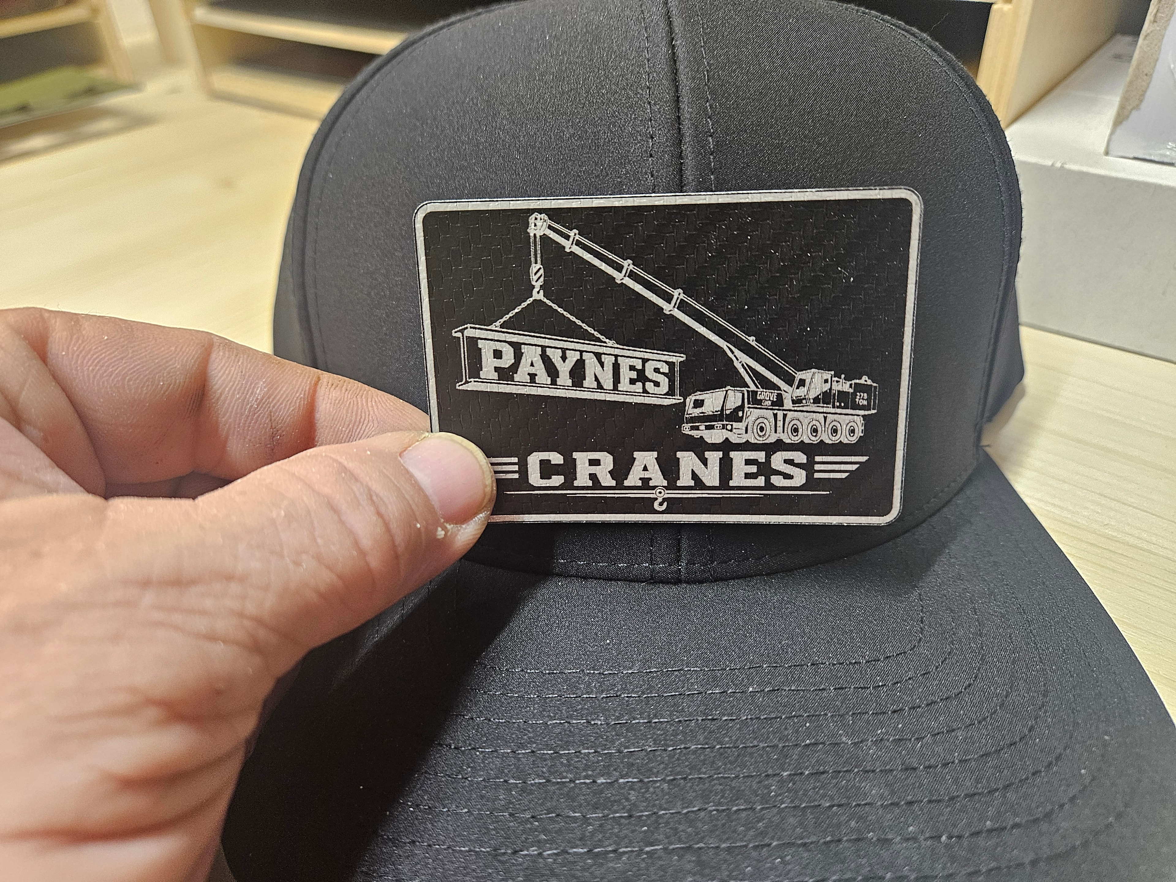Paynes Cranes black hat with laser-engraved metal patch