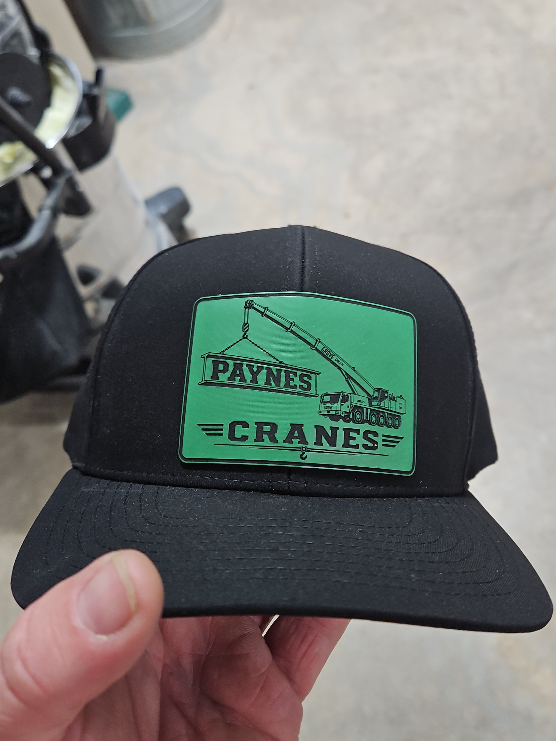Paynes Cranes black hat with green laser-engraved patch