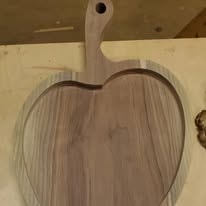 Apple-shaped walnut cutting board with handle