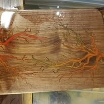 Rectangular wood board with orange and red epoxy resin tree branch design