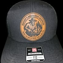 Black Richardson 112 hat with Bigfoot BBQ and Body Disposal round leather patch