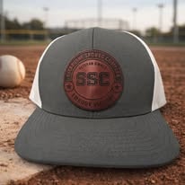 Charcoal and white snapback with SSC Sportsmanship Sports Complex round leather patch