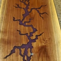 Walnut board with blue resin river inlay